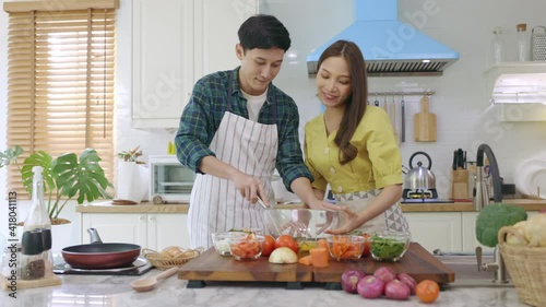 Newly married couple Help each other cook happily, having fun at home. Couples spend time together making lovely, happy meals.