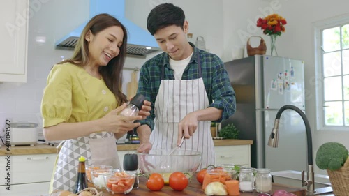 Newly married couple Help each other cook happily, having fun at home. Couples spend time together making lovely, happy meals.