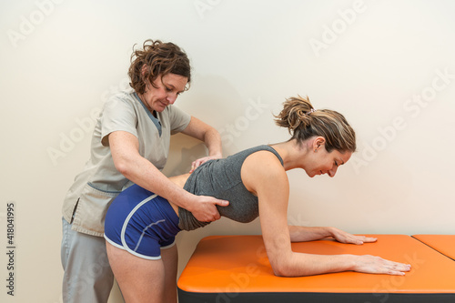 Фотография Physiotherapist and patient in Global Postural Re-education session, spinal corr