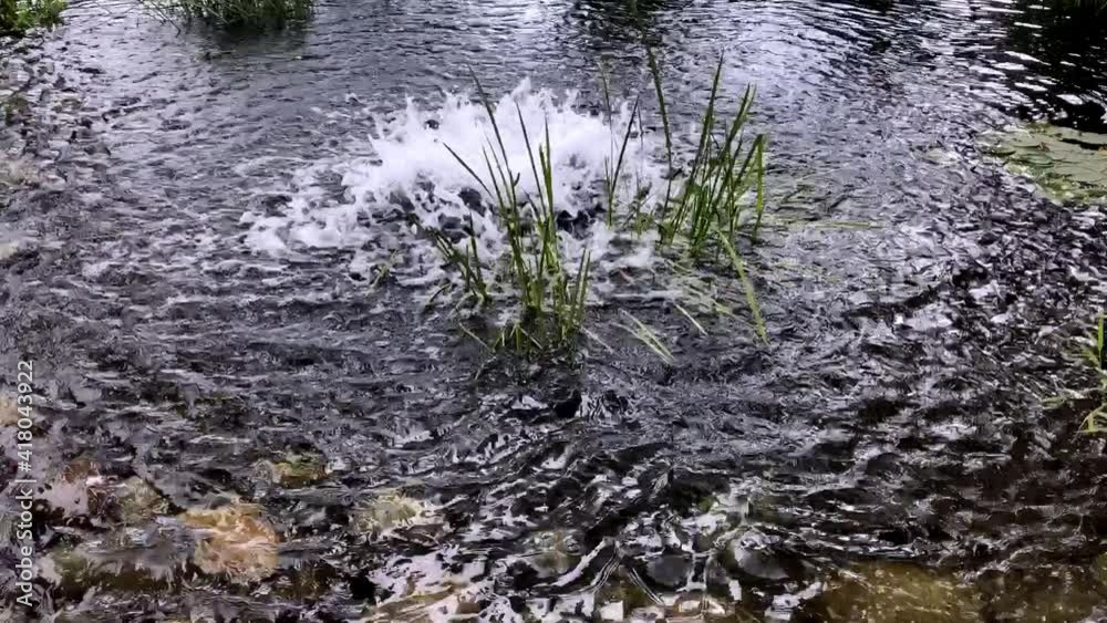 stone shore of the seething river of the lake