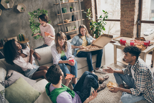 Photography Photo portrait of students sitting in room talking at party eating pizza drinkin