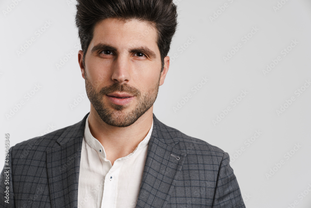 Handsome young man in jacket posing and looking at camera Handsome young man in jacket posing and looking at camera