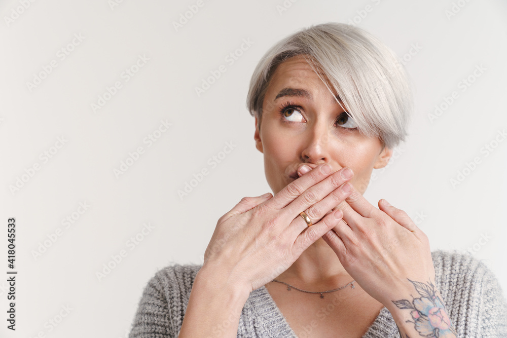 Beautiful silver girl covering her mouth and looking upward Beautiful silver girl covering her mouth and looking upward