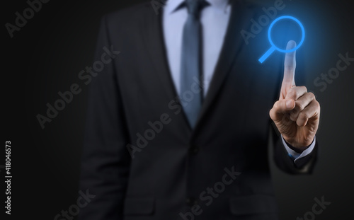 Businessman, man hold in hand magnifying glass icon.business, technology and internet concept
