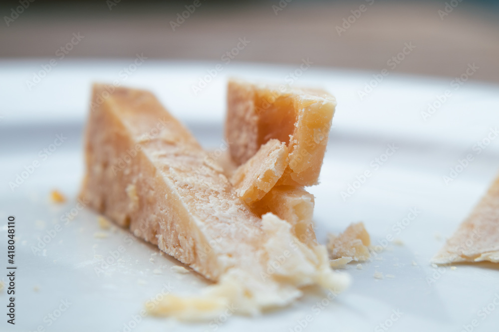 Pieces of hard cheese on a plate