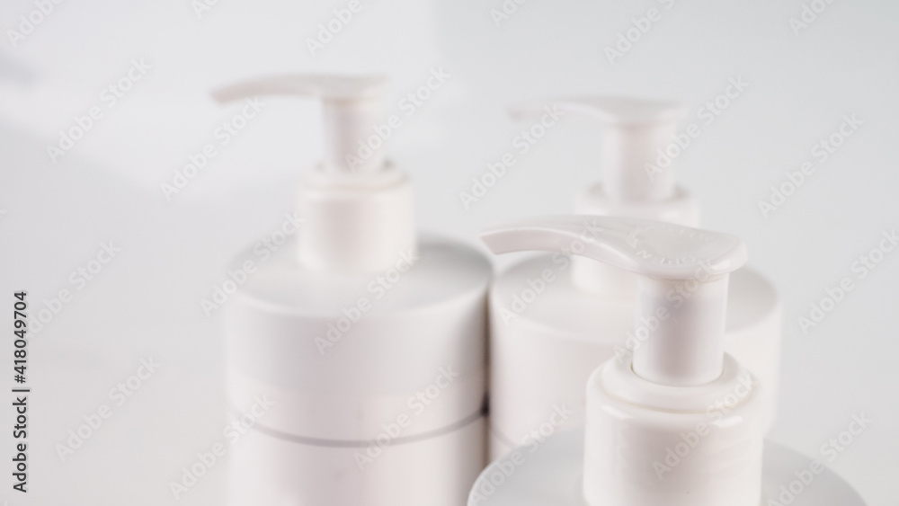 several bottles with a dispenser close-up several bottles with a dispenser close-up