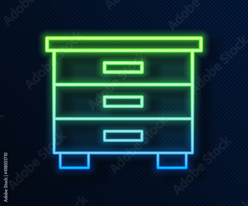 Glowing neon line Furniture nightstand icon isolated on blue background. Vector.