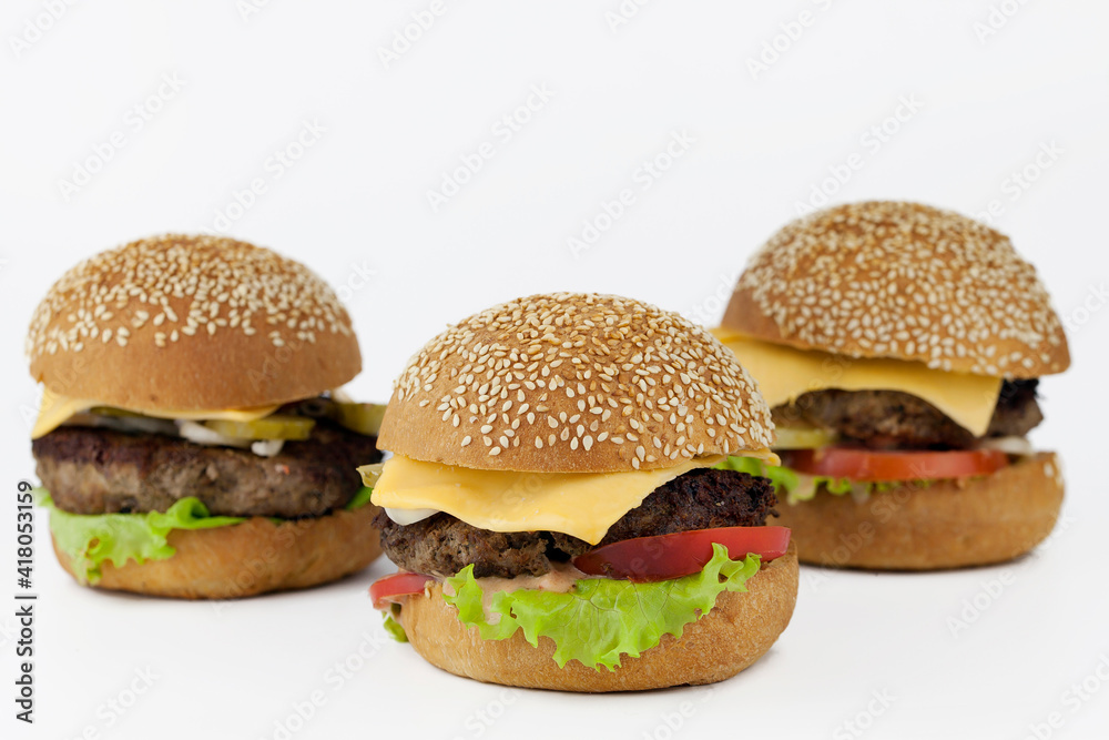 Group of burgers isolated on light background, background out of focus Group of burgers isolated on light background, background out of focus