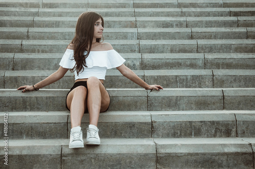 Teenage girl sitting on steps, Spain photo