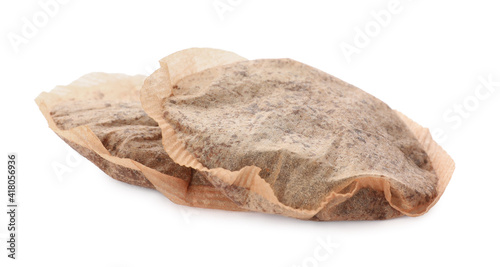 Two used tea bags on white background