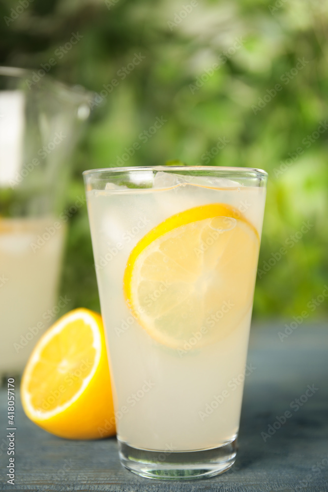 Cool freshly made lemonade in glass on blue table Cool freshly made lemonade in glass on blue table