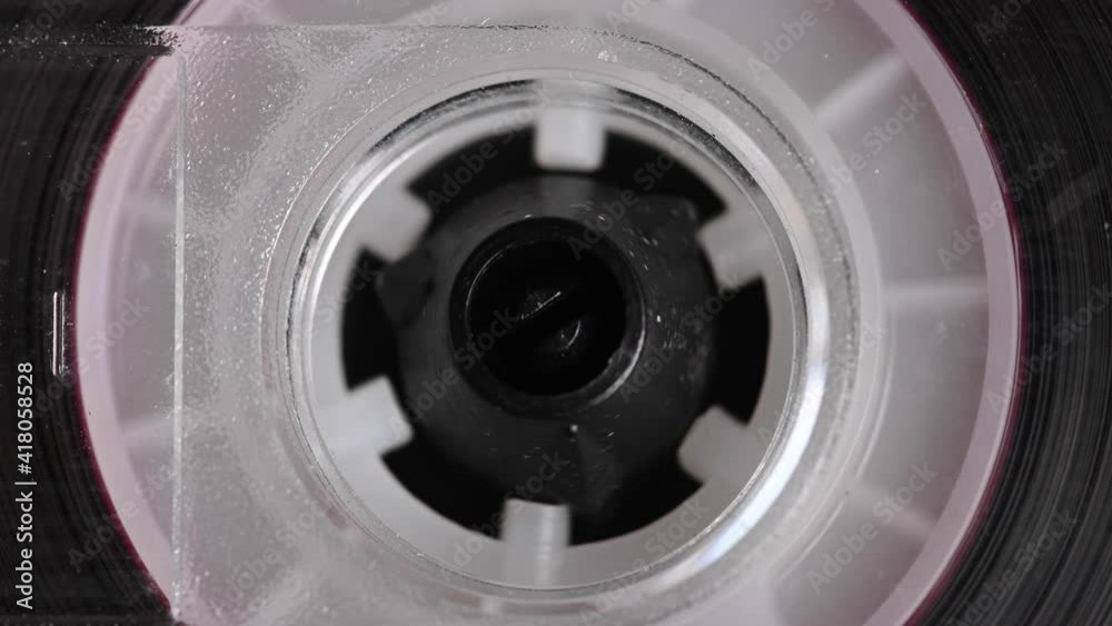 Close-up element of audio cassette. Macro rotation of the reel with audio tape