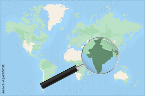 Map of the world with a magnifying glass on a map of India.
