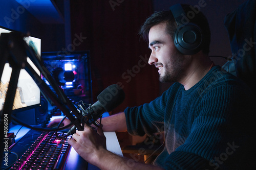 Young gamer playing video games online while broadcasting on social media - Working live streaming on internet platforms