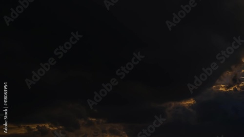 Timelapse 4K. Fast-moving dramatic thick clouds at sunset.