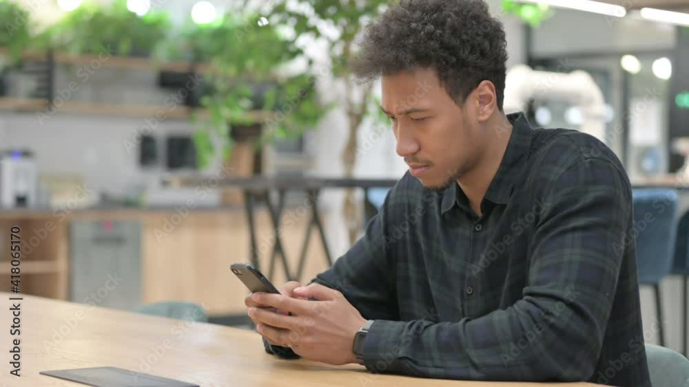 Attractive African American Man using Smartphone at Work Attractive African American Man using Smartphone at Work
