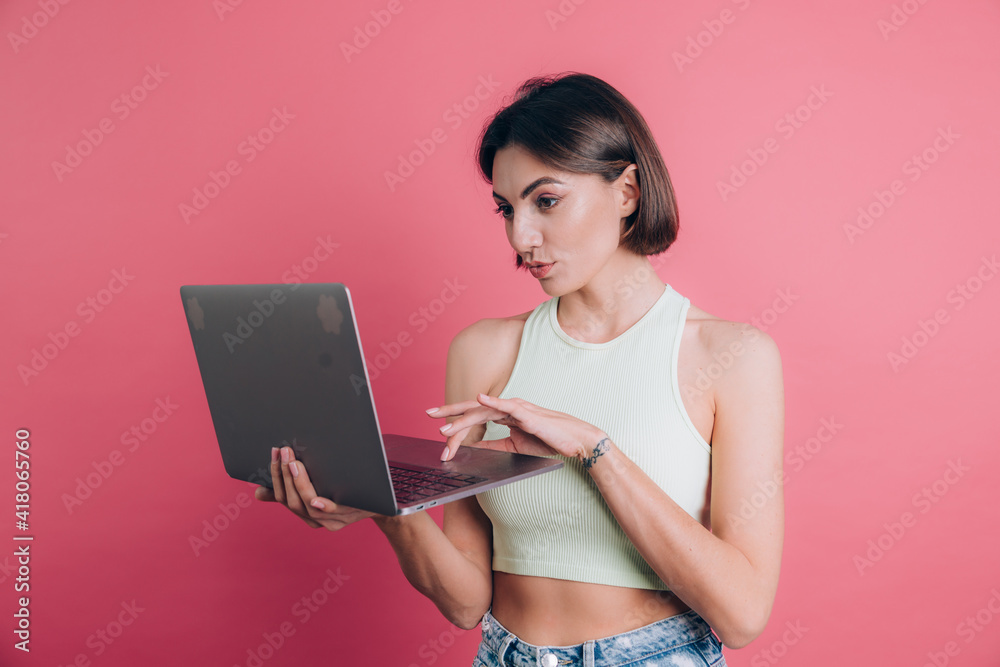 Women on pink background pretty smiling holding laptop pc