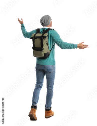 Man with backpack walking on white background, back view. Autumn travel