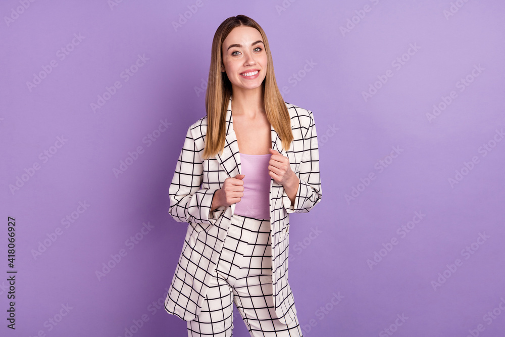 Photo portrait of cheerful business woman in checkered blazer smiling happy isolated on pastel purple color background Photo portrait of cheerful business woman in checkered blazer smiling happy isolated on pastel purple color background