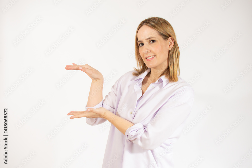 Beautiful young woman holding something over white background Beautiful young woman holding something over white background