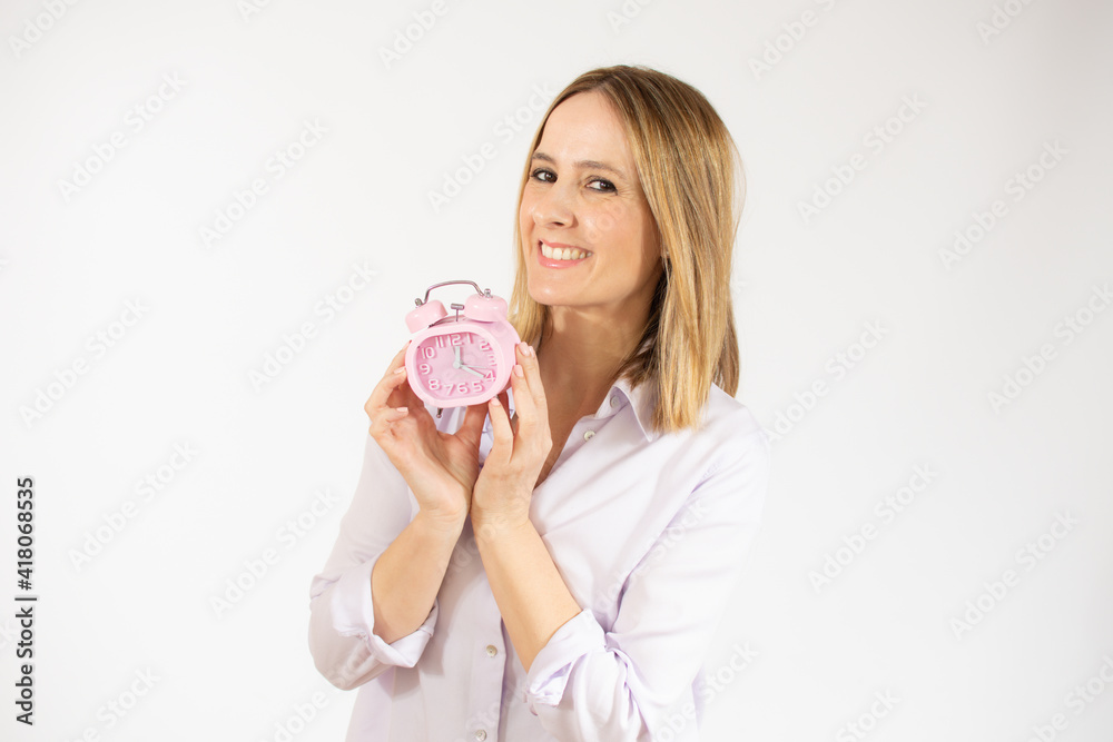 Portrait of cheerful young woman holding alarm clock isolated over white background Portrait of cheerful young woman holding alarm clock isolated over white background