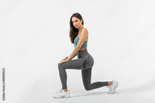 Fitness woman doing lunges exercises for leg muscle workout training © Artem Bruk