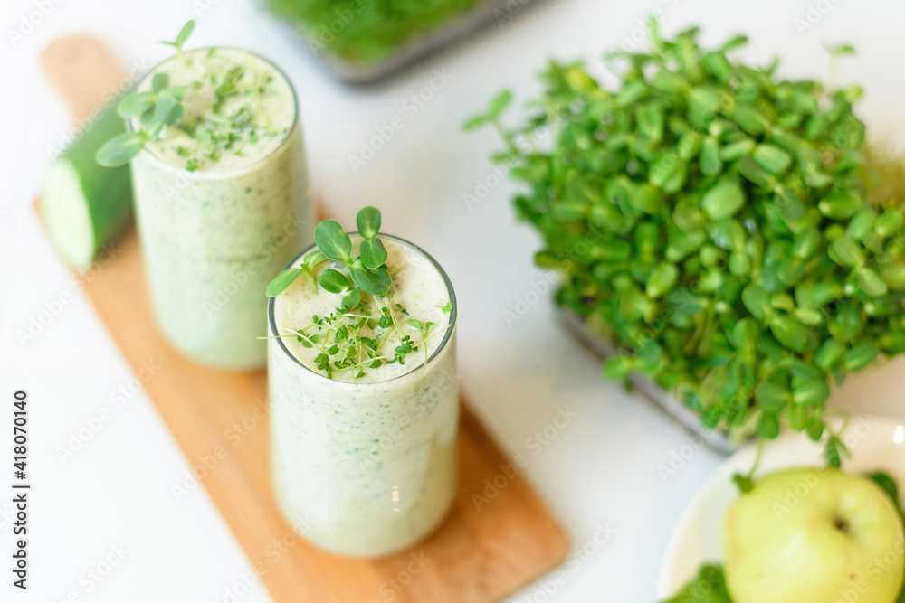 smoothie of micro-green apples cucumber and spinach on a light background. eco organic fresh food detox . ingredients fresh micro-greens . close-up selective focus smoothie of micro-green apples cucumber and spinach on a light background. eco organic fresh food detox . ingredients fresh micro-greens . close-up selective focus