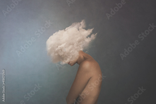 surreal image of a white cloud covering a woman's face, concept of freedom photo