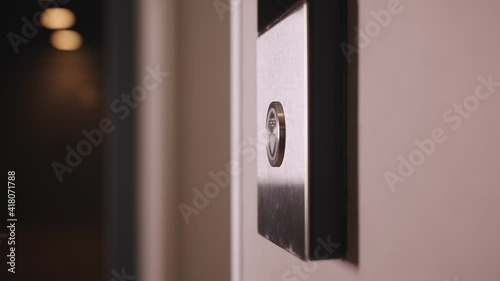 Female Hand Pushing Elevator Button in Office Center or Hotel. Young Woman Pressing Lift Button Up