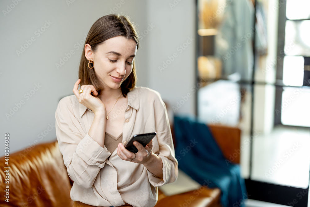 Portrait of cheerful woman using Smartphone on home interior background. Lifestyle concept. Portrait of cheerful woman using Smartphone on home interior background. Lifestyle concept.