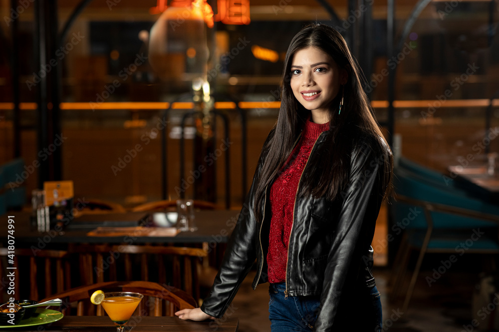 Portrait of a pretty young woman standing stylishly in a restaurant, customer concept. Portrait of a pretty young woman standing stylishly in a restaurant, customer concept.