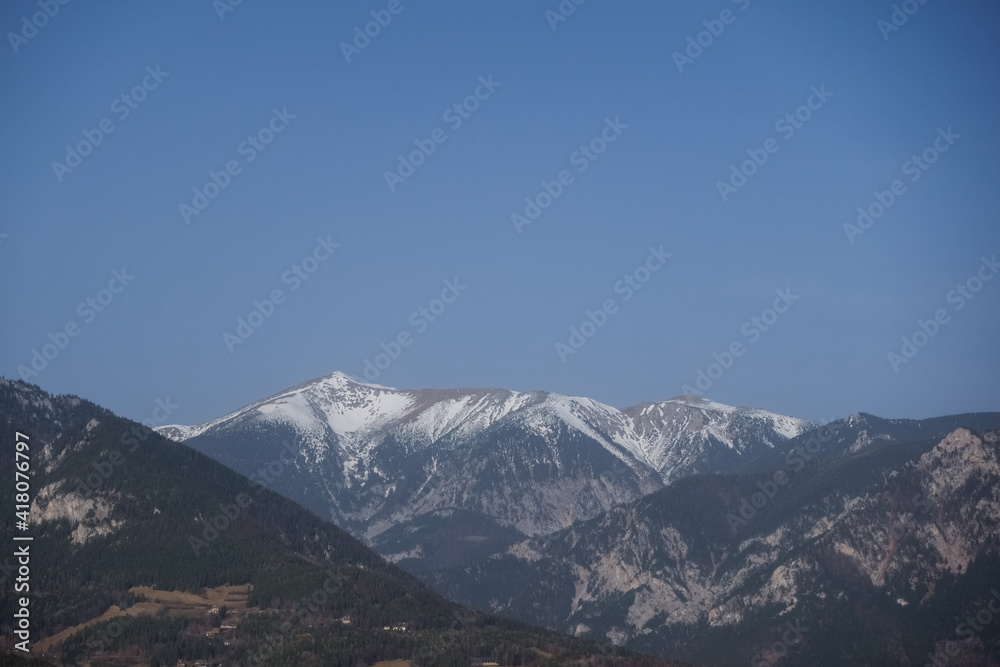 mountains with snow on the top and blue sky