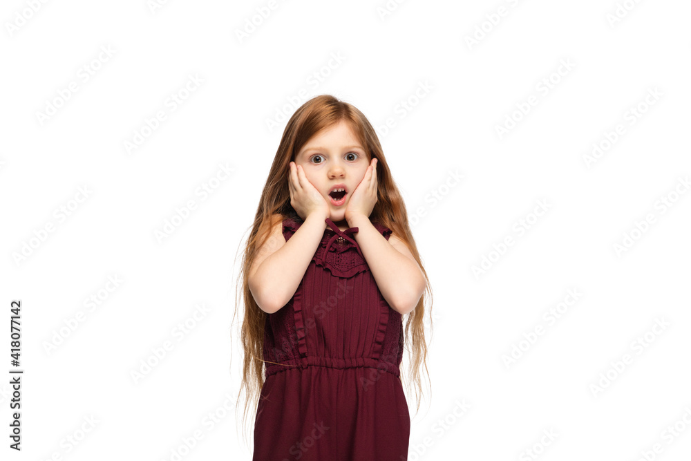 Shy, astonished. Happy, smiley little caucasian girl isolated on white studio background with copyspace for ad. Looks happy, cheerful. Childhood, education, human emotions, facial expression concept. Shy, astonished. Happy, smiley little caucasian girl isolated on white studio background with copyspace for ad. Looks happy, cheerful. Childhood, education, human emotions, facial expression concept.