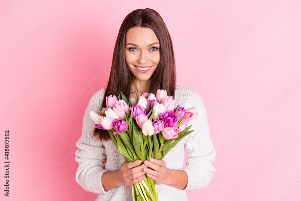 Photo of joyful positive stunning young lady hold tulip flowers holiday spring isolated on pastel pink color background