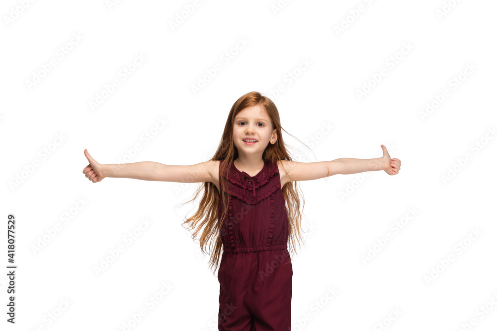 Thumbs up. Happy, smiley little caucasian girl isolated on white studio background with copyspace for ad. Looks happy, cheerful. Childhood, education, human emotions, facial expression concept. Thumbs up. Happy, smiley little caucasian girl isolated on white studio background with copyspace for ad. Looks happy, cheerful. Childhood, education, human emotions, facial expression concept.