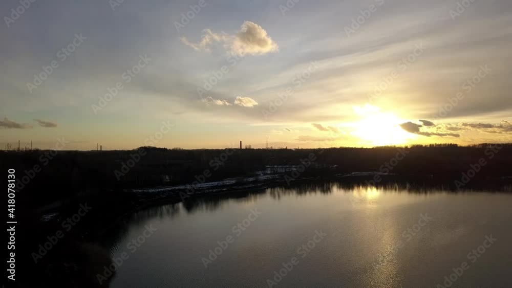 Hovering over a large and big lake at sunset. High quality 4k footage Hovering over a large and big lake at sunset. High quality 4k footage