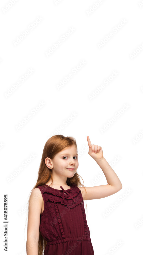 Pointing up, flyer. Happy, smiley little caucasian girl isolated on white studio background with copyspace for ad. Looks happy, cheerful. Childhood, education, human emotions, facial expression Pointing up, flyer. Happy, smiley little caucasian girl isolated on white studio background with copyspace for ad. Looks happy, cheerful. Childhood, education, human emotions, facial expression