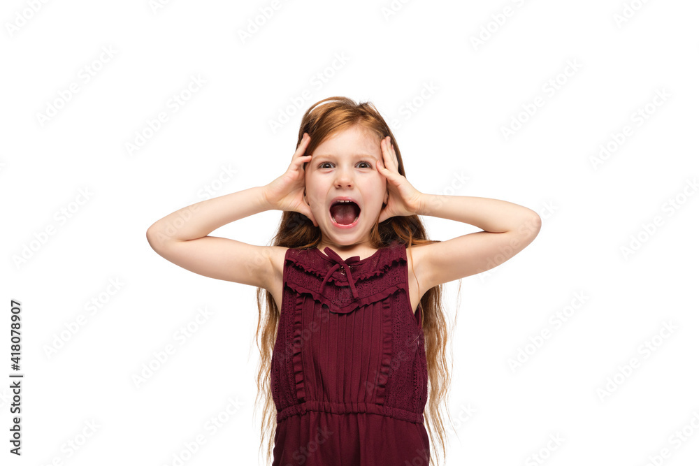 Screaming, closing ears. Happy, smiley little caucasian girl isolated on studio background with copyspace for ad. Looks happy, cheerful. Childhood, education, human emotions, facial expression concept Screaming, closing ears. Happy, smiley little caucasian girl isolated on studio background with copyspace for ad. Looks happy, cheerful. Childhood, education, human emotions, facial expression concept