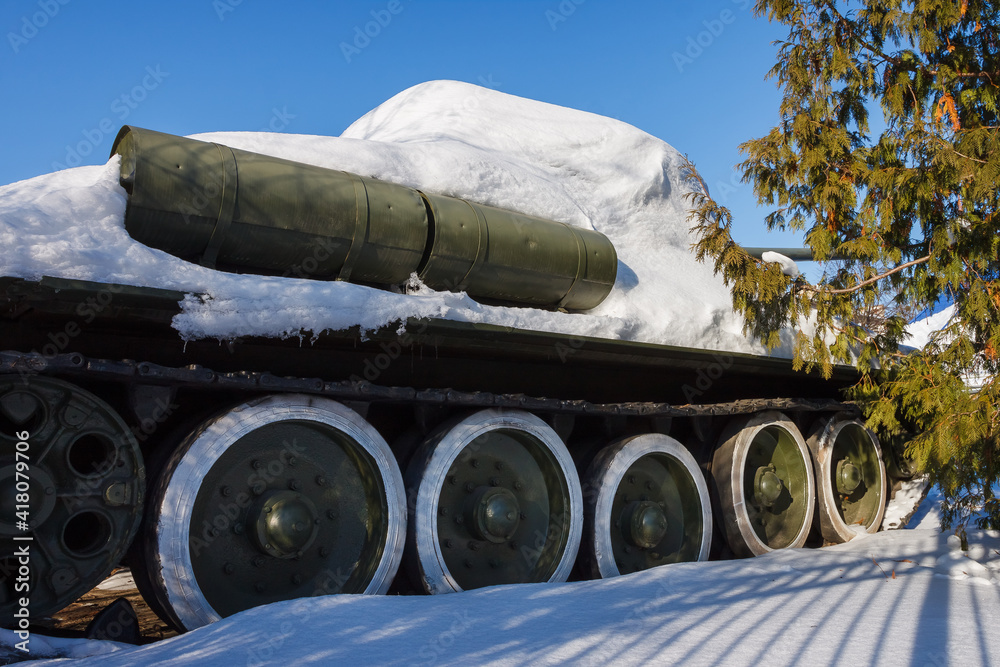 Old Soviet tank covered with snow