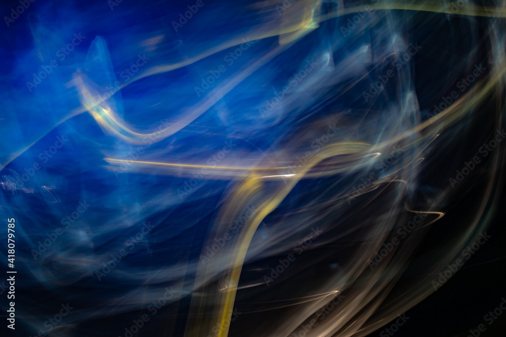 3D rendered or 3D illustration. Abstract shapes of blue and yellow colors on black background. Abstract art made with light painting.