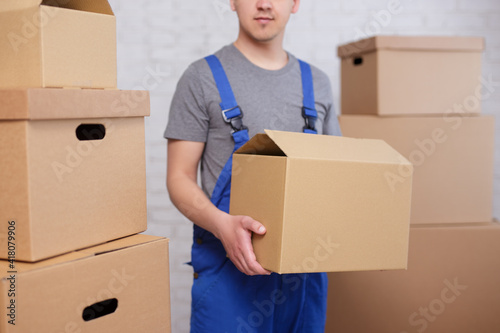 close up of loader holding a box in warehouse or post office