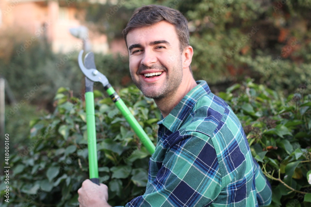 Fototapeta premium Young man using garden scissors 
