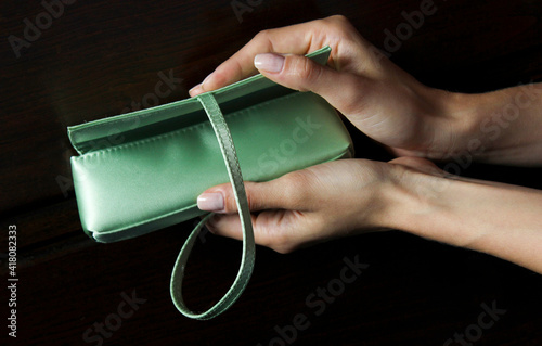 Perfumes Mint Jade Green Satin Cosmetic Pouch Silky Elegant Luxury and Perfume. Woman's hands presenting the products