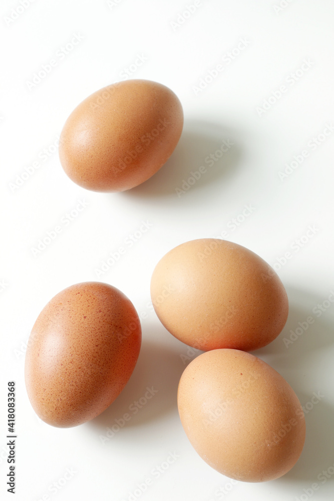 minimalism food photography, raw fresh brown egg on white background minimalism food photography, raw fresh brown egg on white background