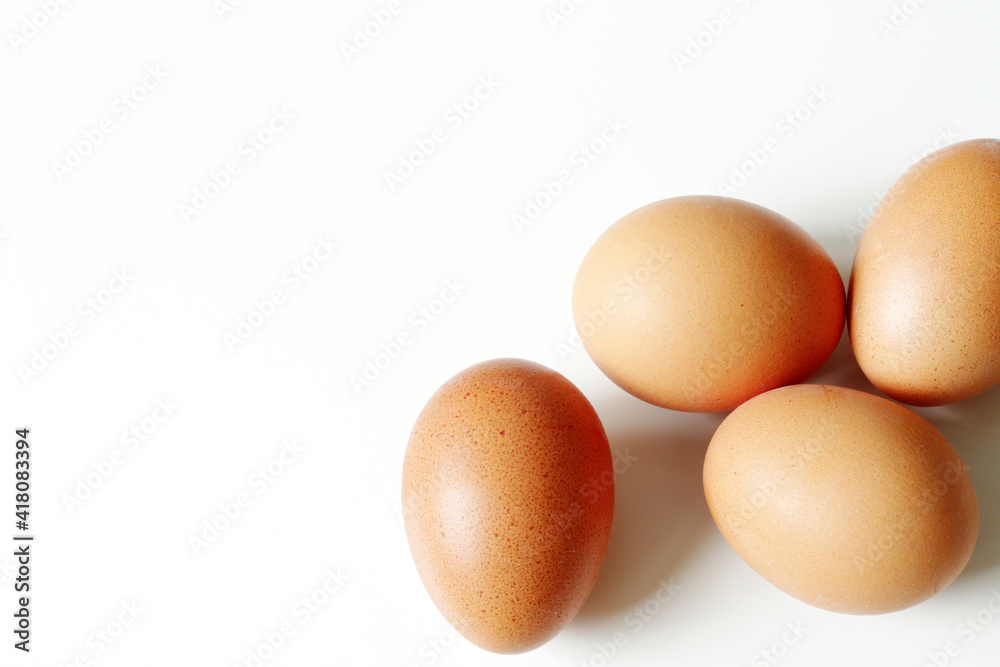 minimalism food photography, raw fresh brown egg on white background minimalism food photography, raw fresh brown egg on white background