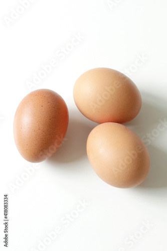 minimalism food photography, raw fresh brown egg on white background