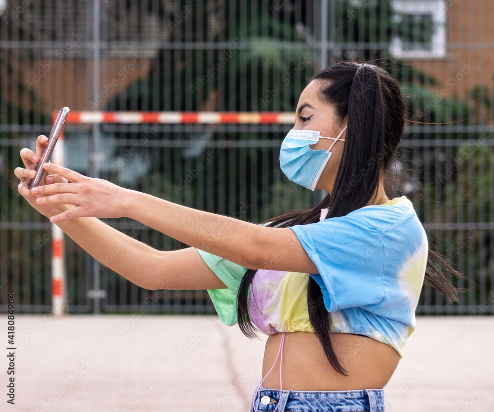 girl with surgical mask taking a selfie