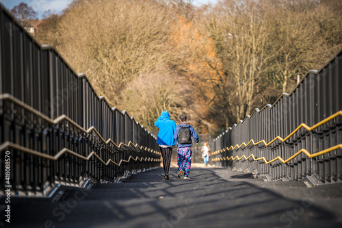 Kids bunking off school truanting when they should be in classroom, children walking over bridge from schools entrance to get in trouble avoid lessons and education 