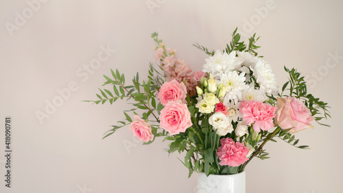 Bouquet of fresh spring flowers on light pink wall background  © Adelina