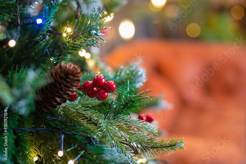 Merry Christmas and New Year holidays background. Beautiful decorated christmas tree. Beautiful decorated fireplace and Christmas tree at cottage.